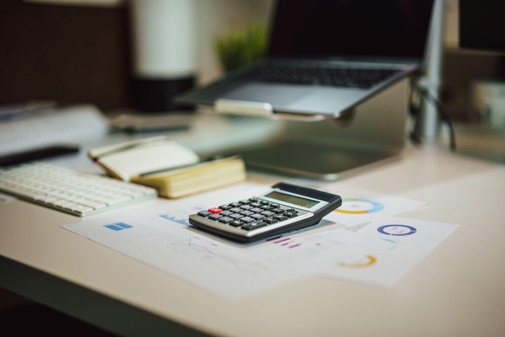 Calculator on a desk next to budget paperwork
